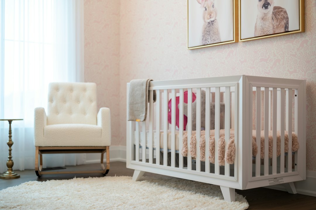 A cozy nursery with a white crib and armchair