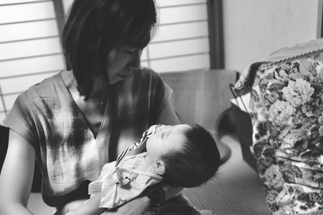 A woman holding a baby in her lap