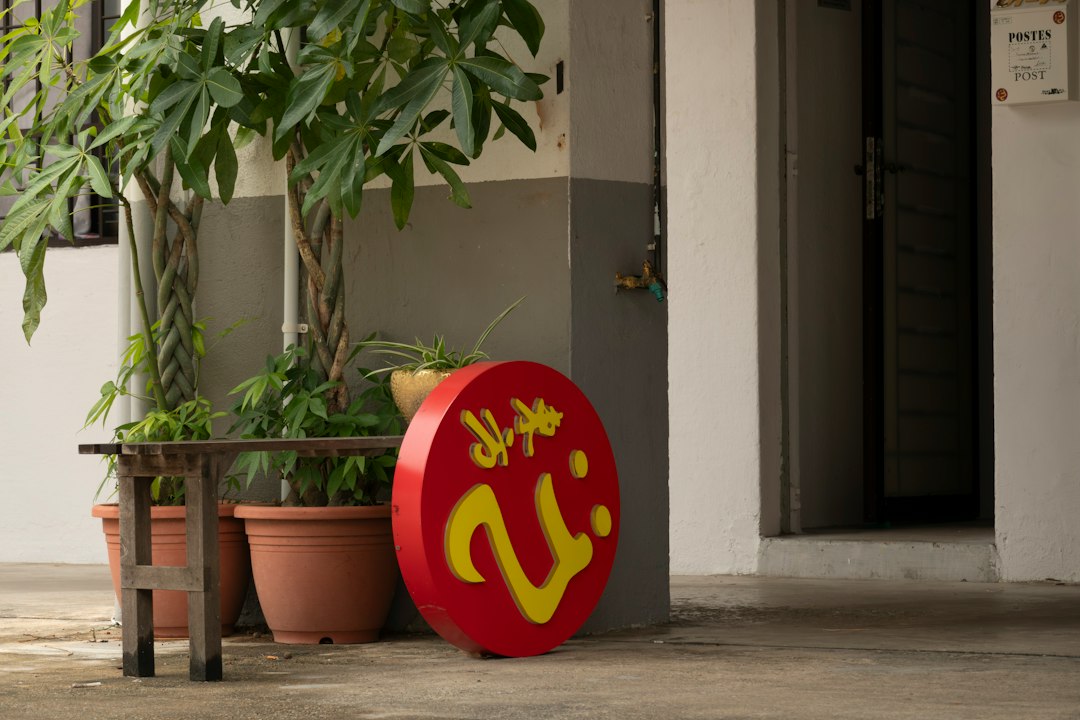 a red sign sitting on the side of a building