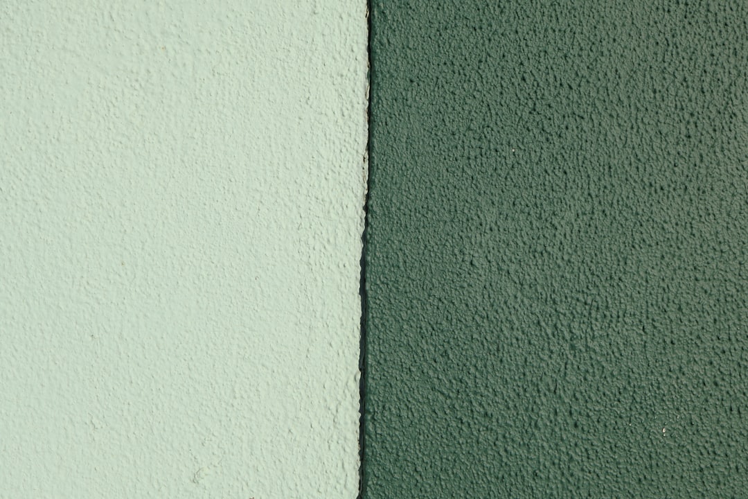 Two textured walls, one light green, one dark green