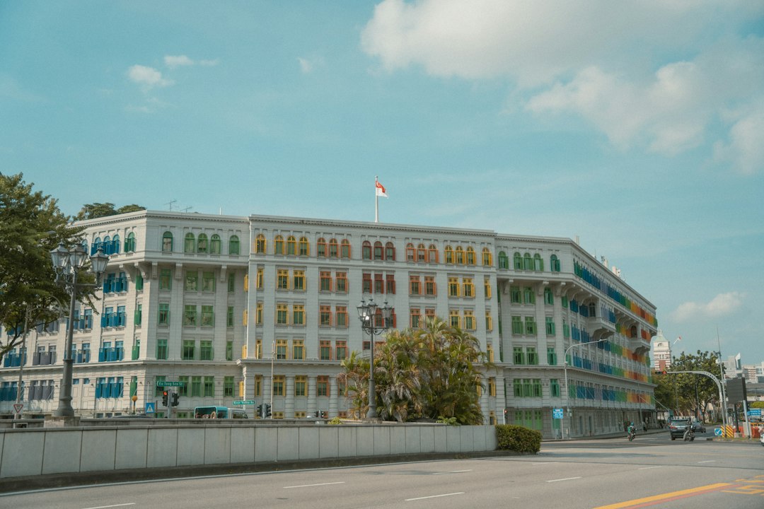 a large white building with green and yellow windows