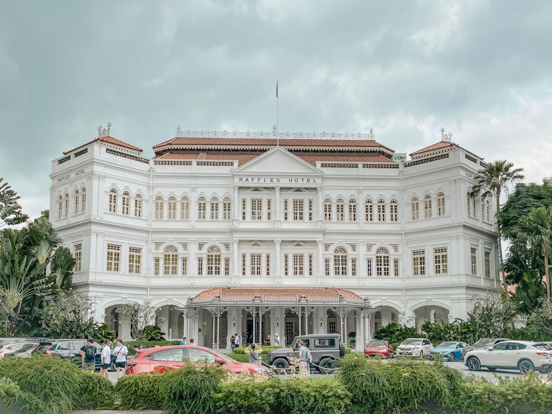 a large white building with cars parked in front of it