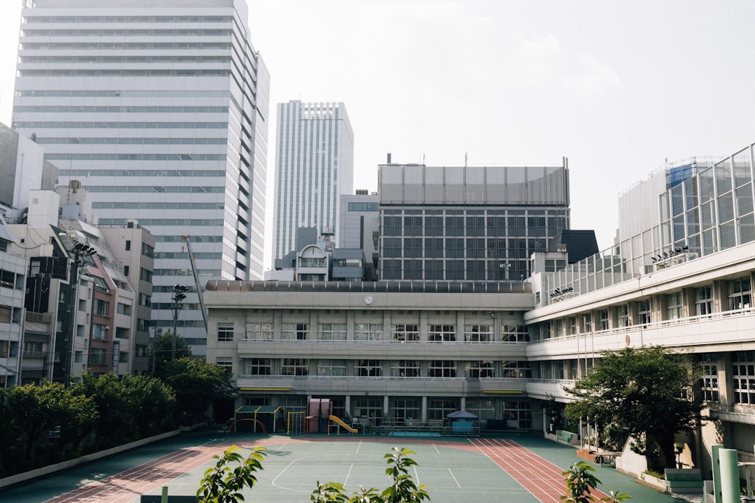School building with modern skyscrapers in background