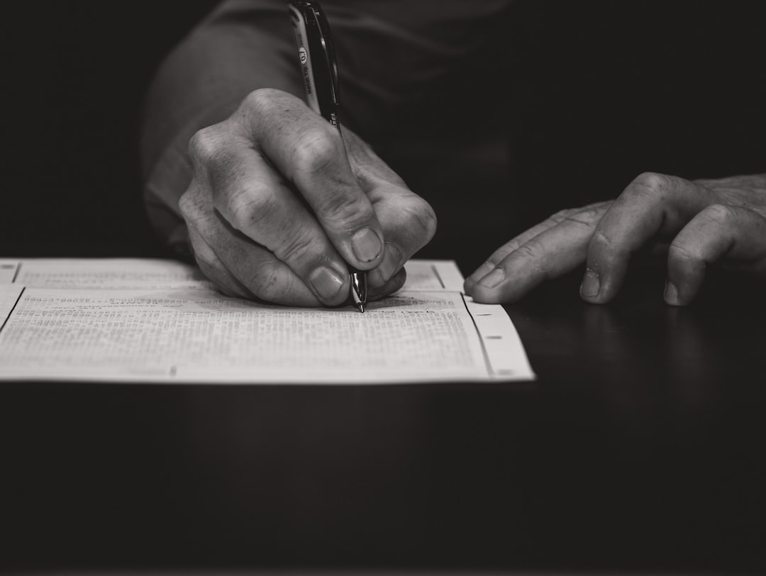 Hand writing with a fountain pen on paper.