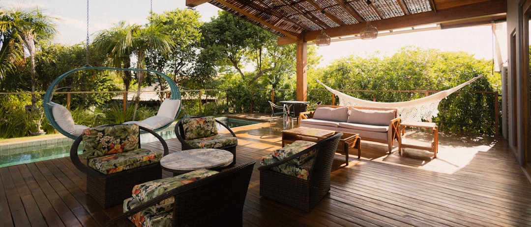 Covered patio with seating, hammock, and pool view.