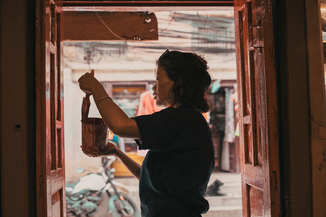 Woman holding a small leather bag indoors