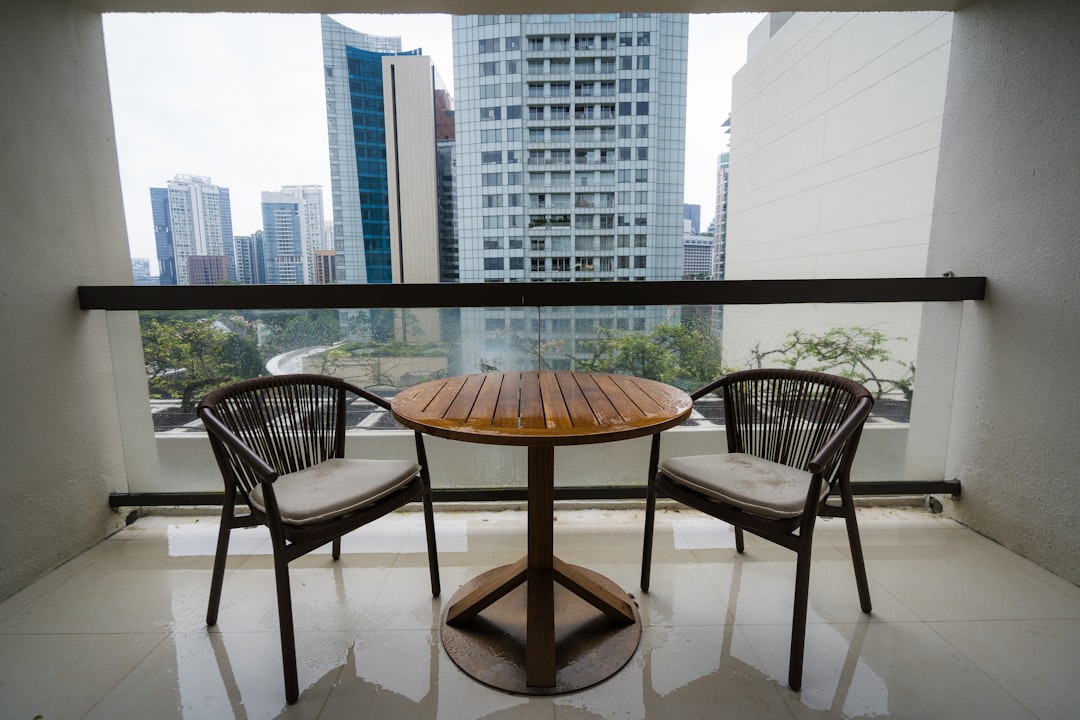 Two chairs and a table on a balcony