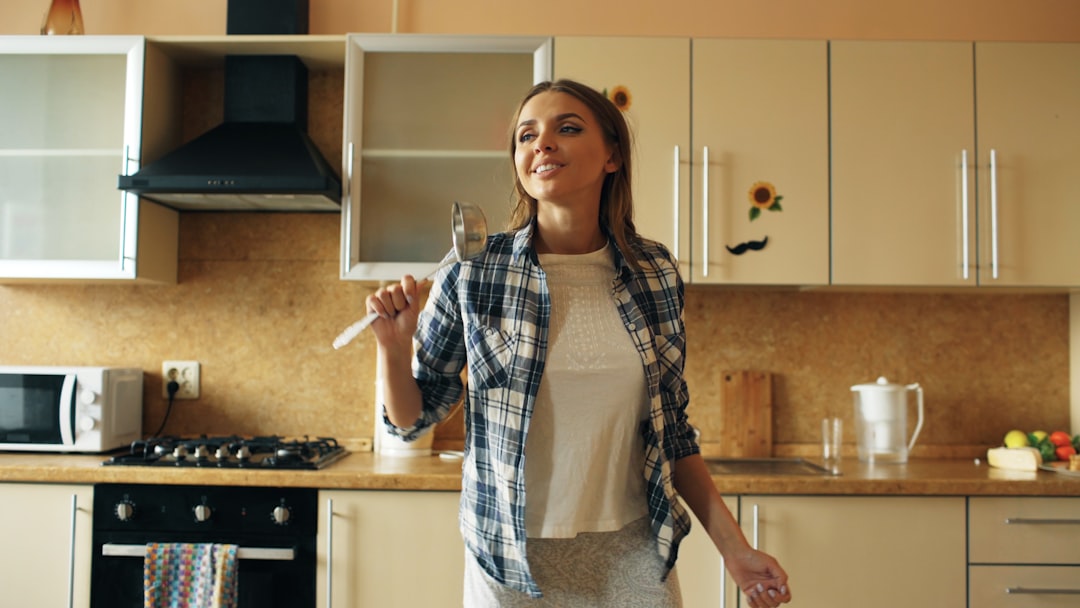 Woman singing and dancing in a kitchen