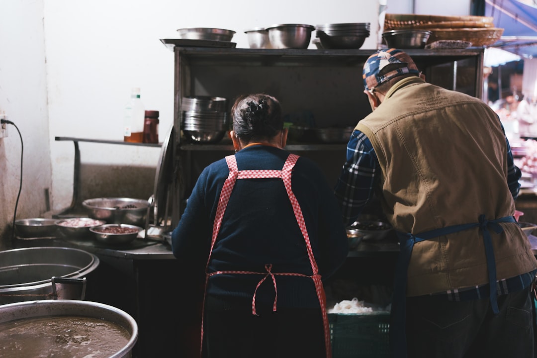 Two people working in a busy kitchen