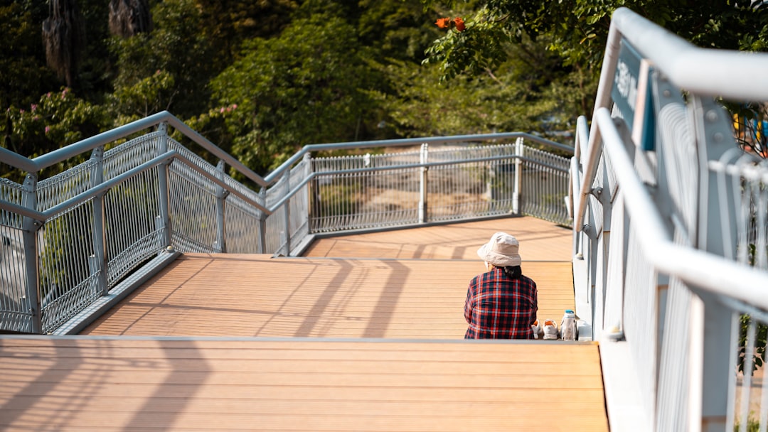 A person sitting on a ramp with trees in the background