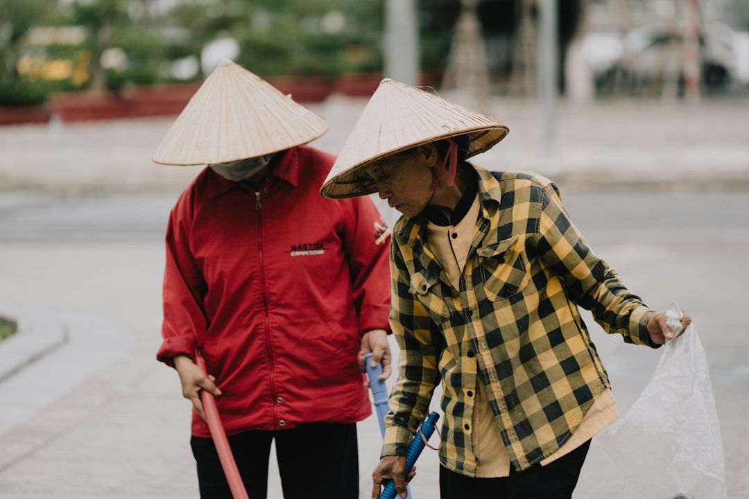 Two workers are seen picking up litter