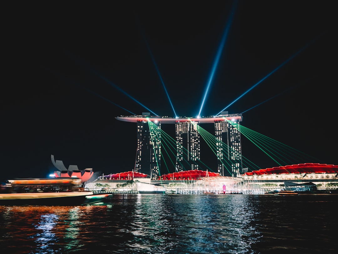 A night scene of a pier with boats and lights
