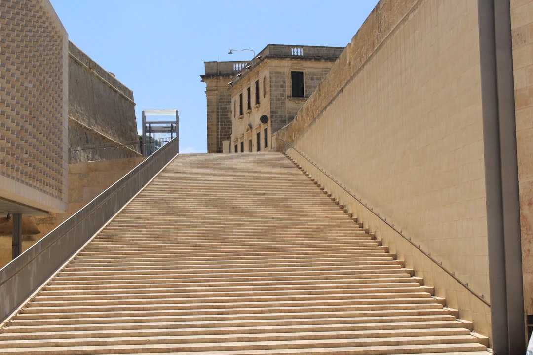 a stone walkway between two buildings