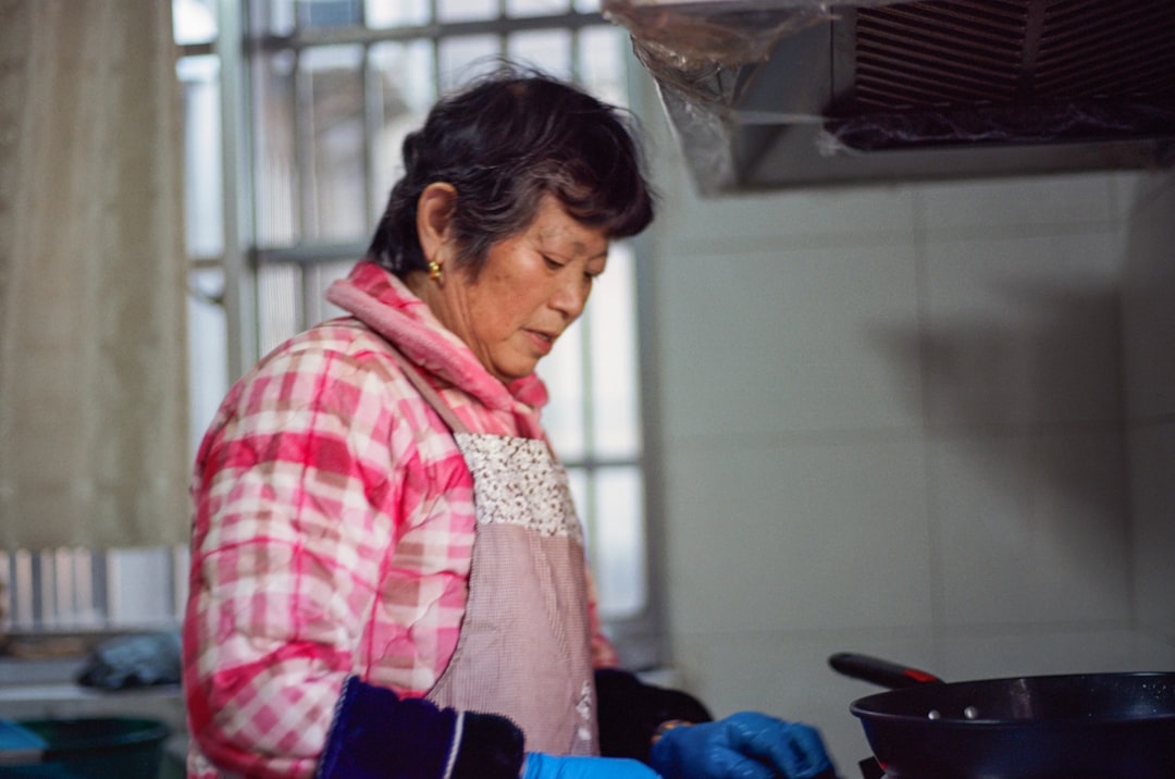 A woman standing in a kitchen preparing food