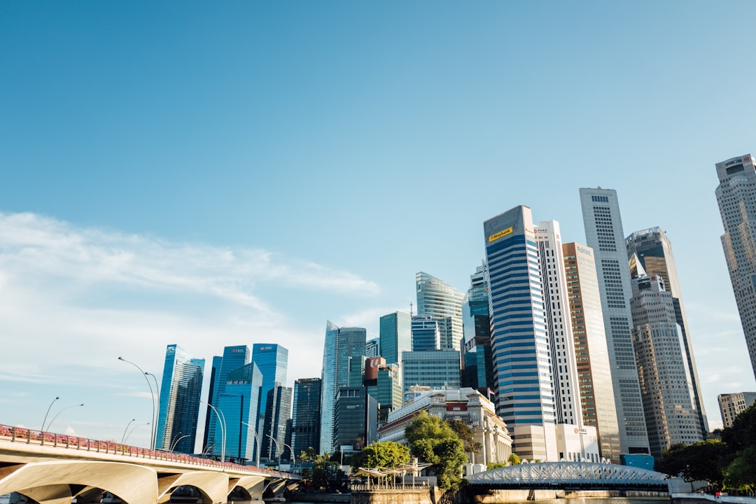 a city skyline with tall buildings and a bridge