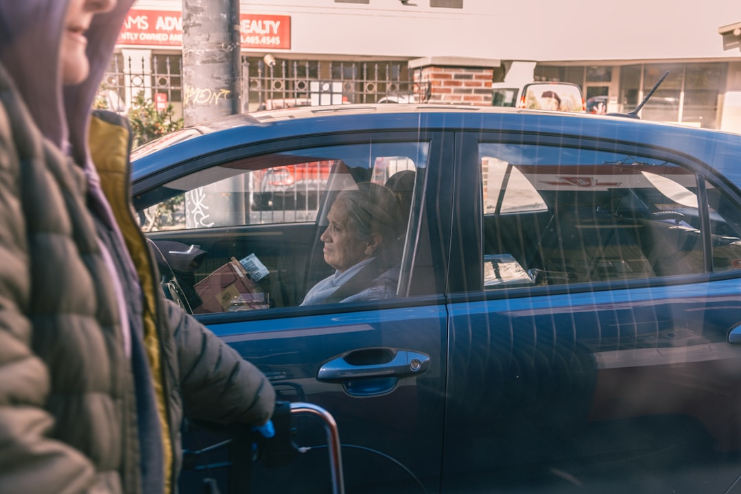 Woman in car looking out window at street