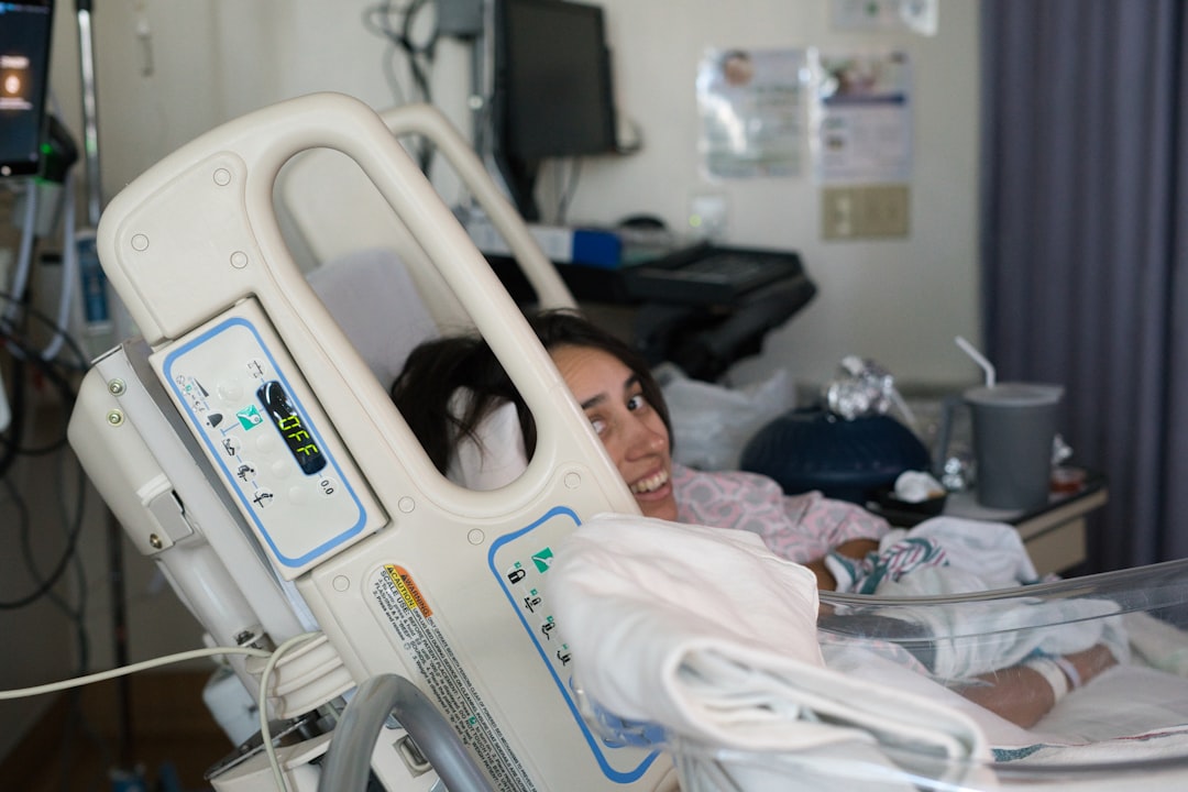 Young woman smiling in hospital bed