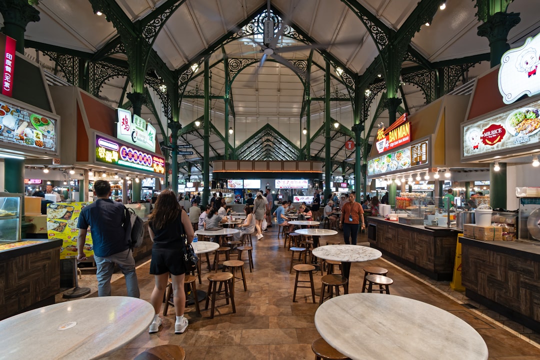 A group of people walking through a food court