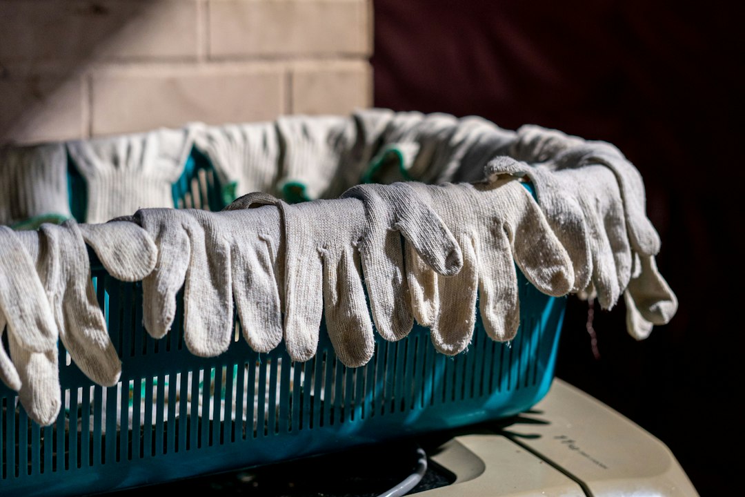 Gloves are hanging over the edge of a basket