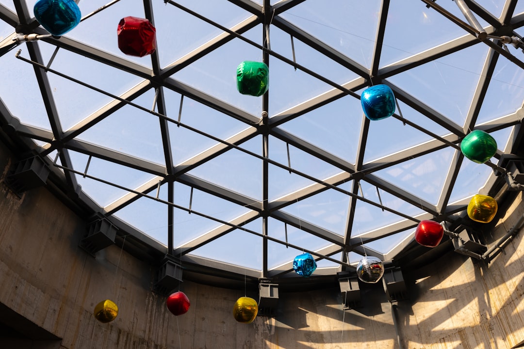 A ceiling with a bunch of different colored balls hanging from it