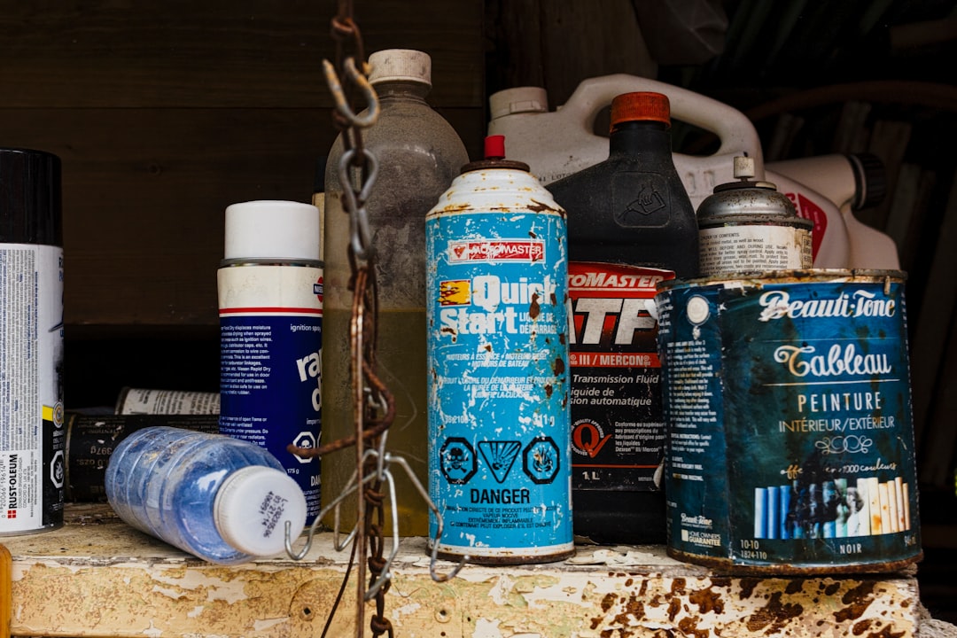 a bunch of spray paint sitting on top of a table