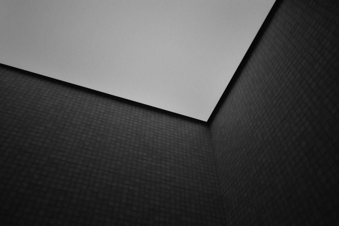A plain white surface overlaps a dark textured background