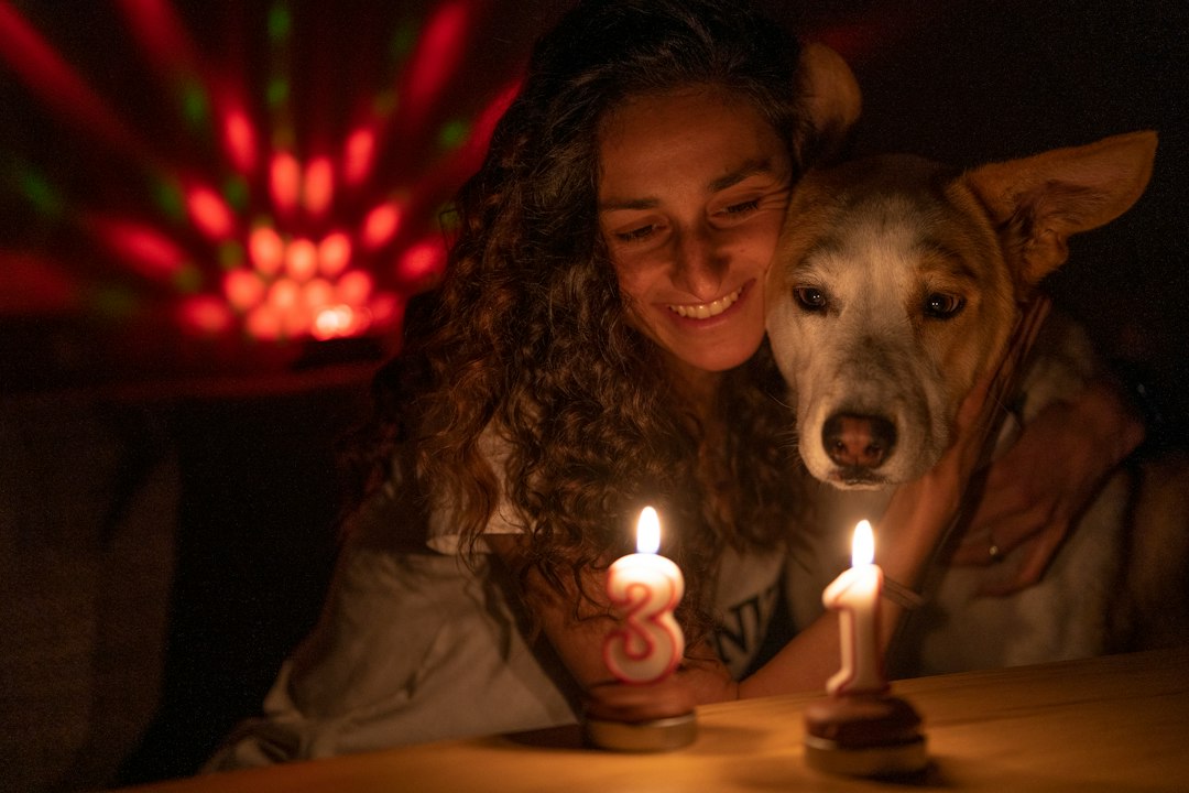 Woman and dog with candles and disco light