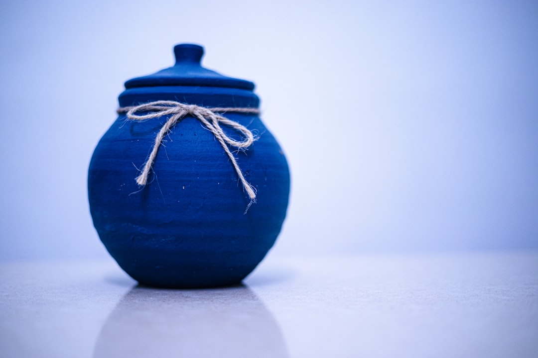 A blue jar decorated with a simple bow