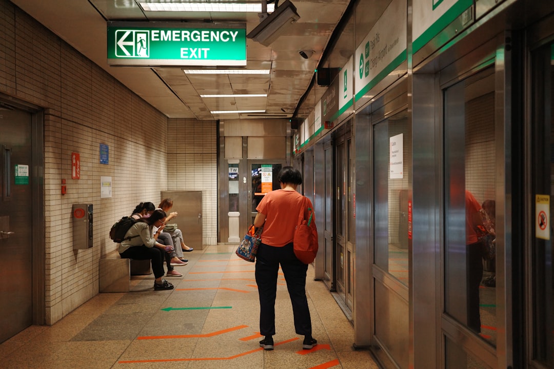 A group of people sitting on a bench in a hallway