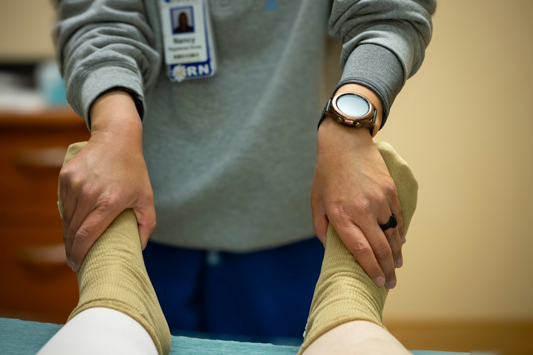 A nurse is performing physical therapy
