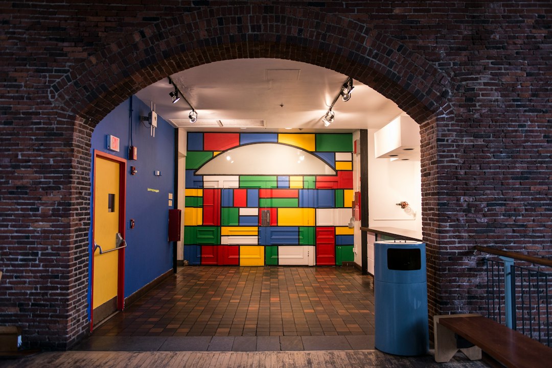 Colorful block wall in a vibrant room through brick archway
