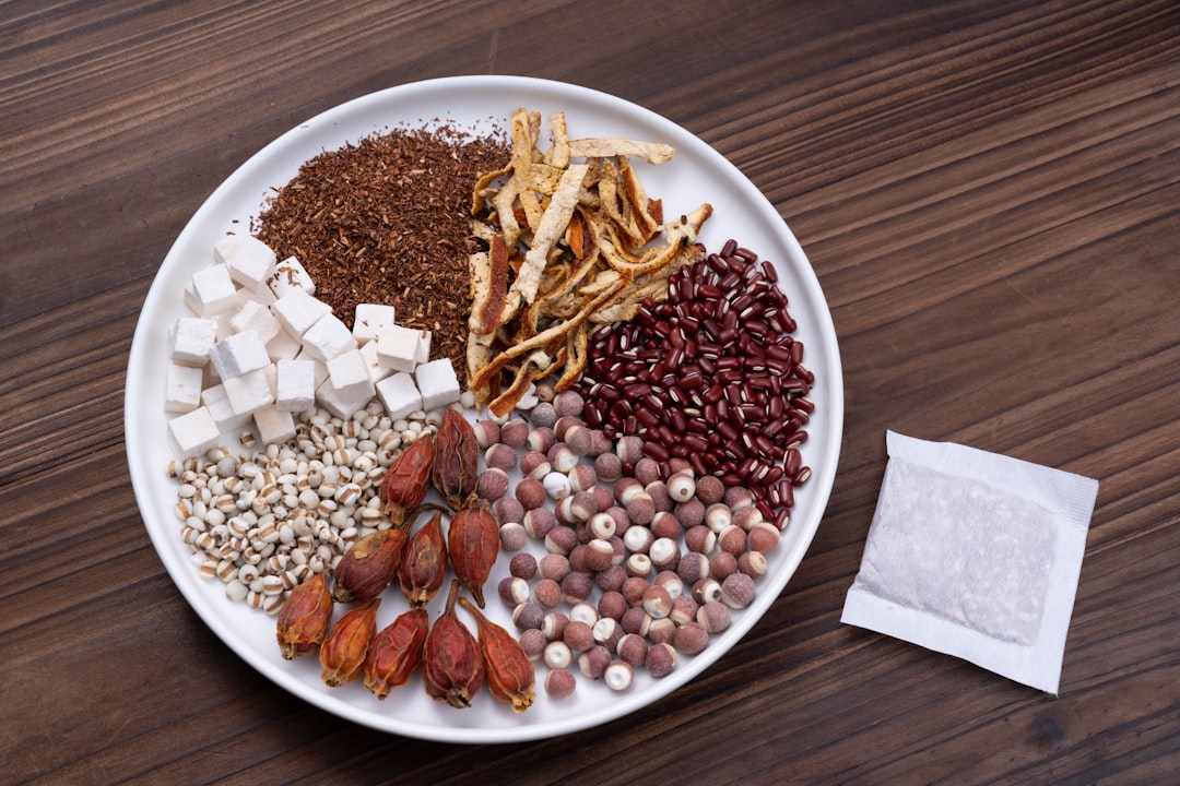 brown and white beans on white ceramic bowl