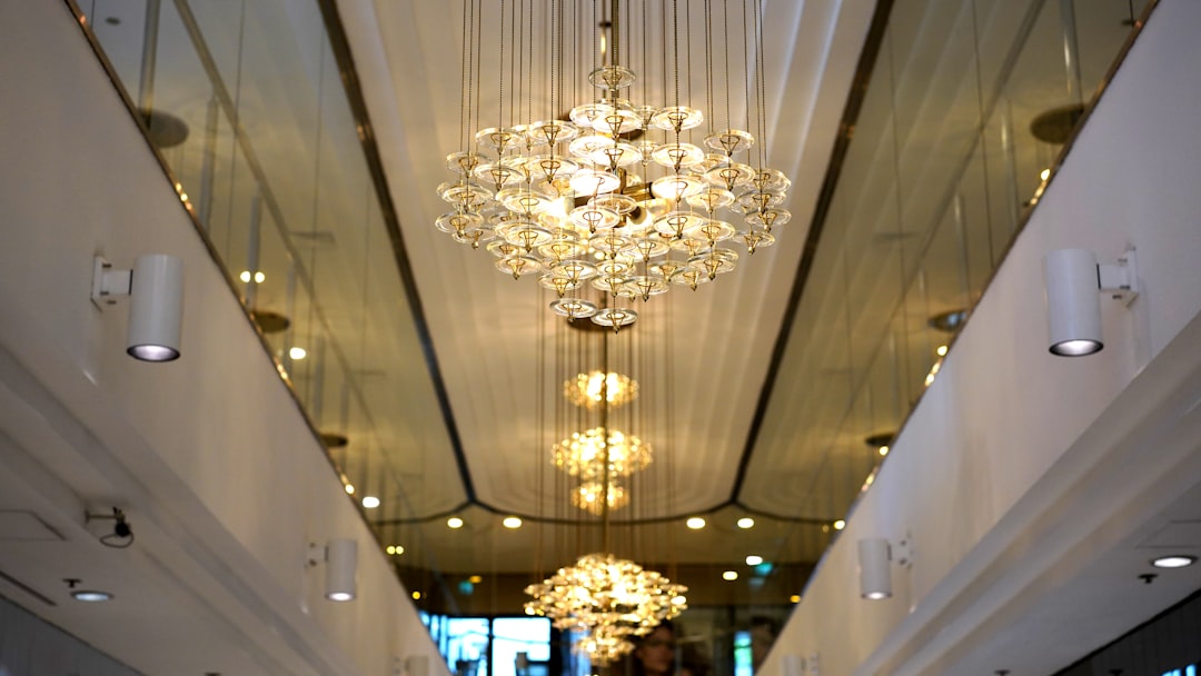gold and white chandelier turned on in a room