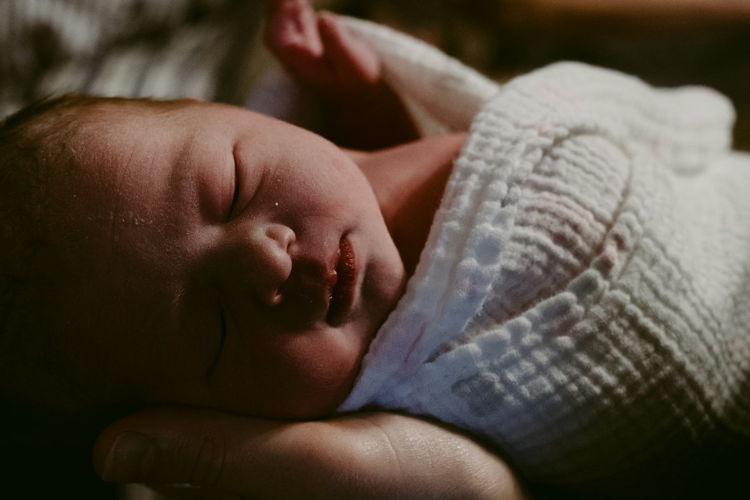 a baby sleeping on a blanket
