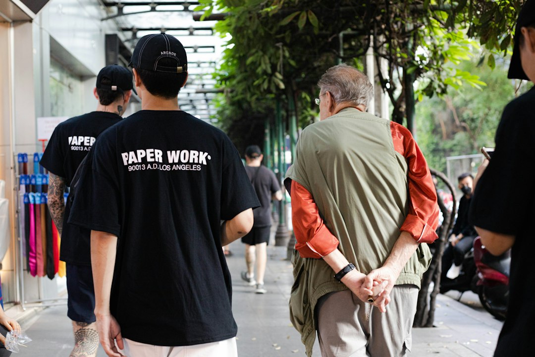 A group of men walking down a sidewalk