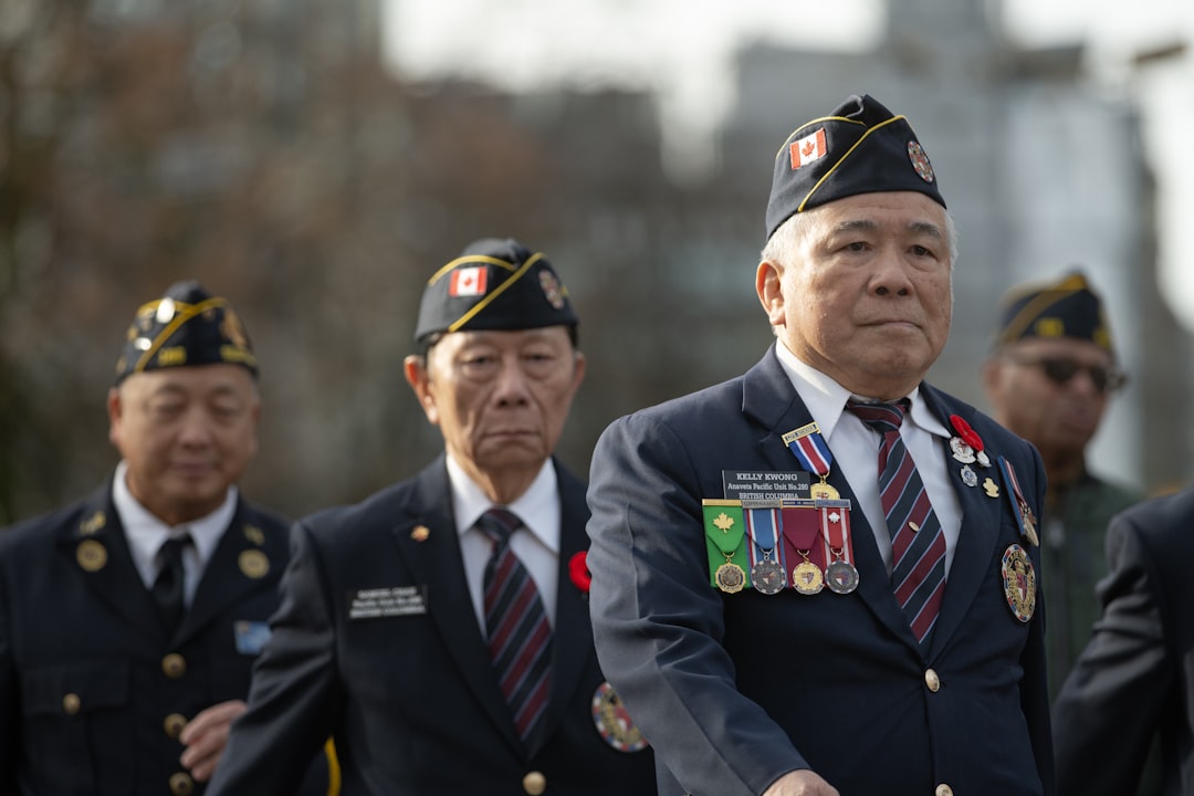 Veterans in uniform marching with medals