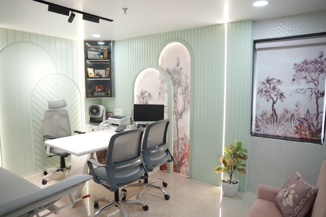Modern office with desk, chairs, and computer.