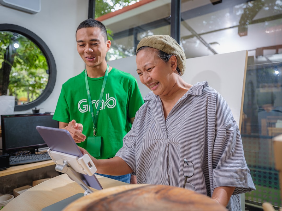 a man and a woman looking at a tablet