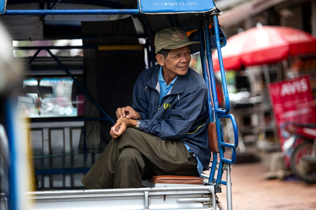 A man sitting in the back of a truck