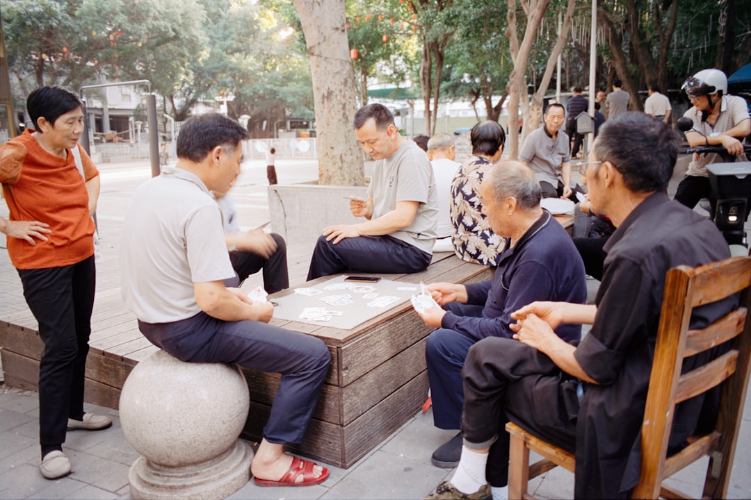 Elderly people playing a board game outdoors