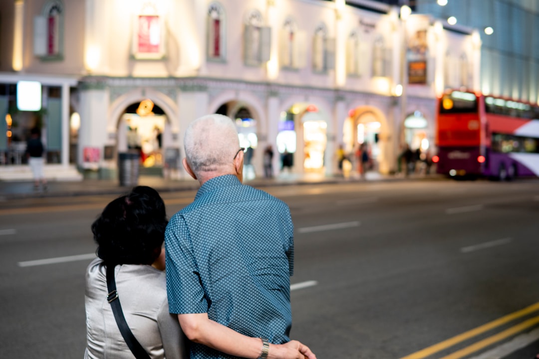 A man and a woman walking down a street