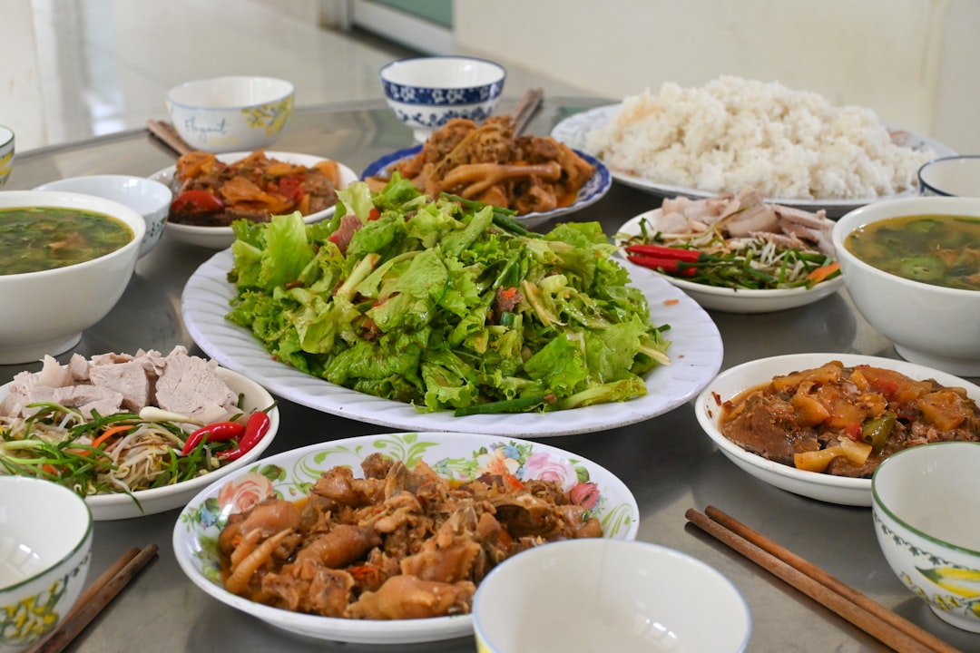 A table is filled with delicious vietnamese food.
