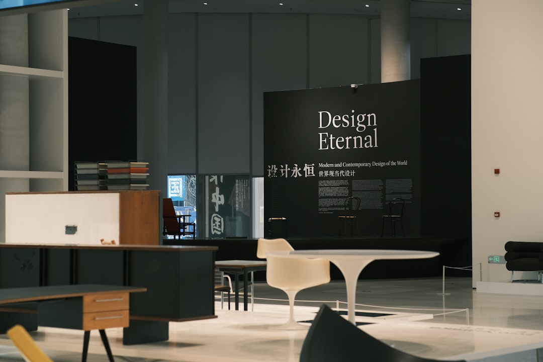 Modern exhibition space with minimalist furniture and signage.