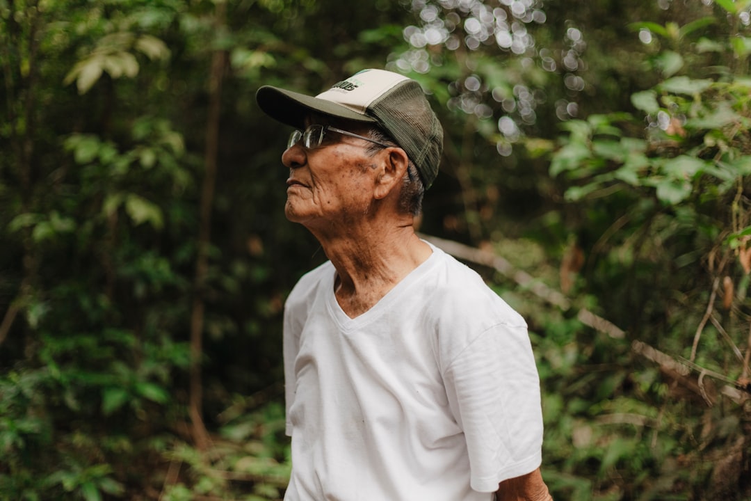 A man standing in the woods with a frisbee