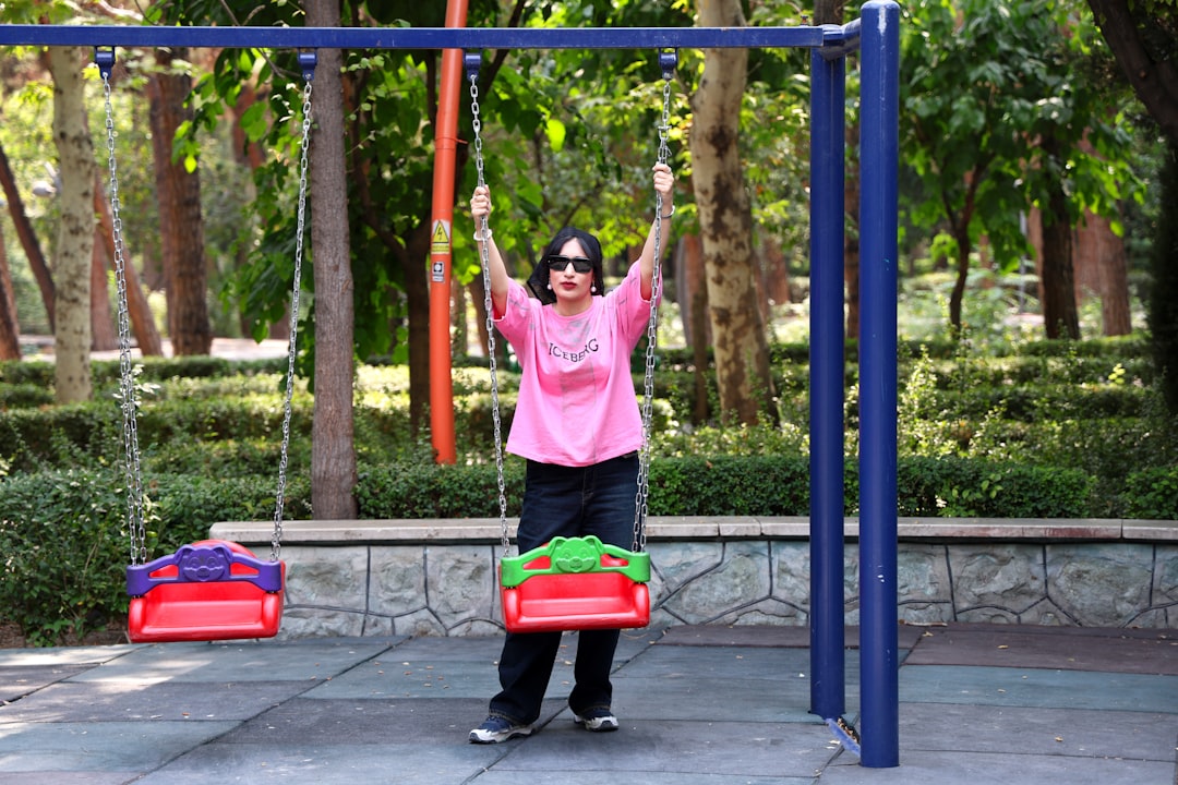 Woman on a swing set in a park