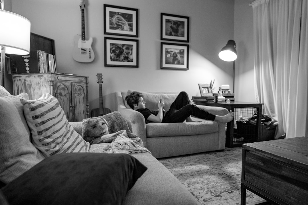 Woman relaxing on couch with child nearby