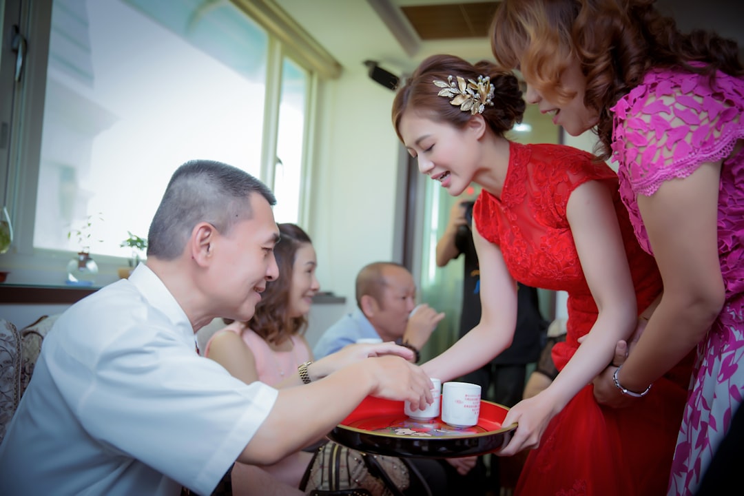 a woman in a red dress and a man in a white shirt