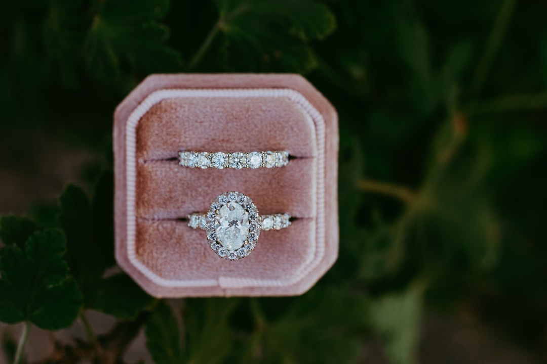 A couple of engagement rings sitting on top of a velvet box