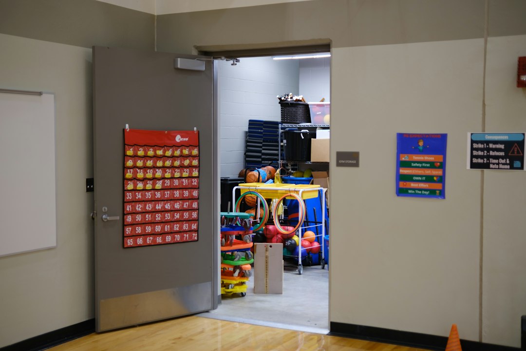 An open door to a gym storage room filled with sports equipment