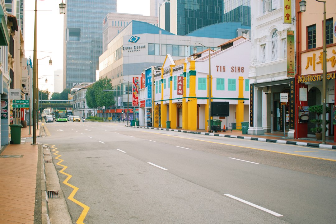 gray concrete road between buildings during daytime